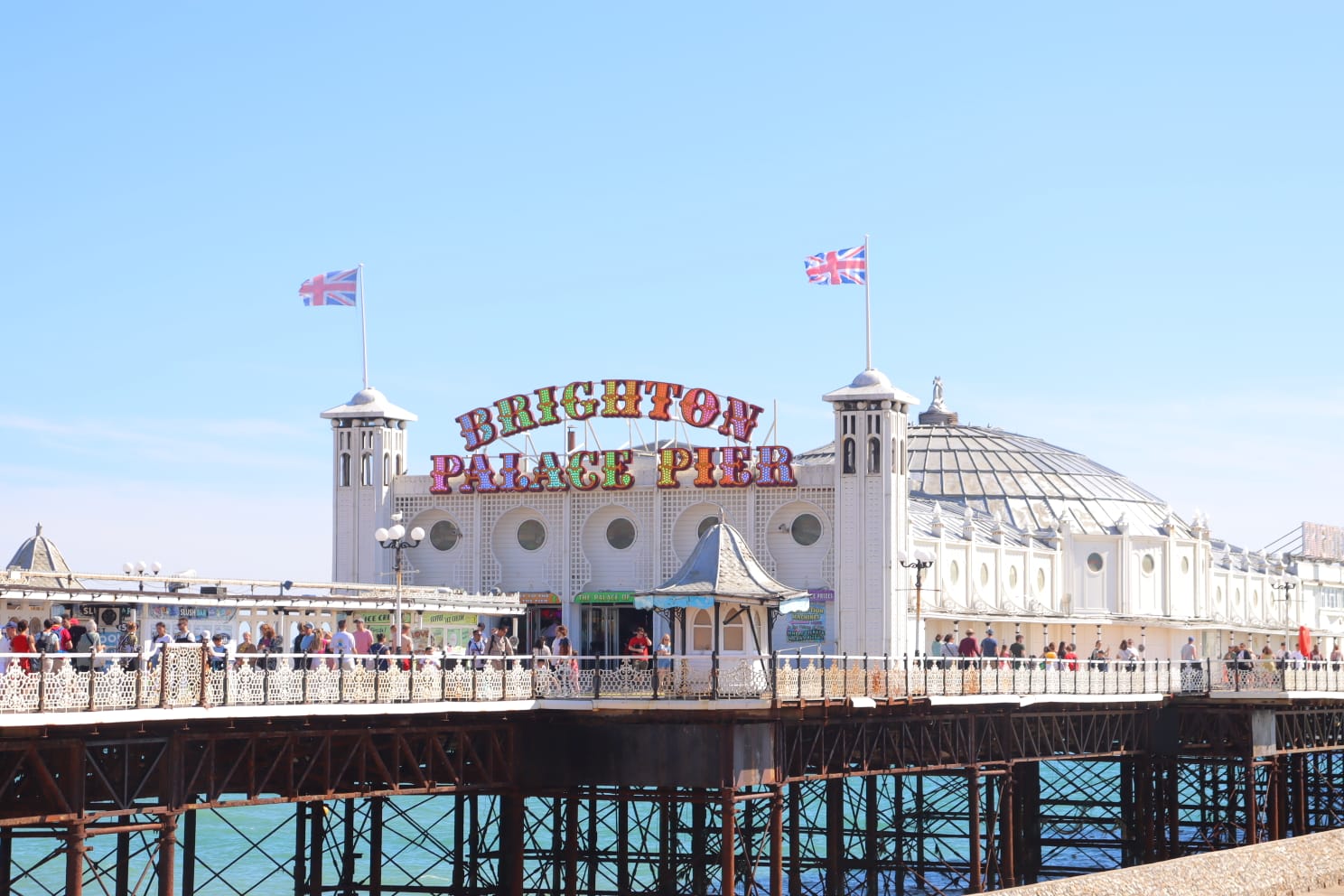 Big white building which says "Brighton Palace Pier"