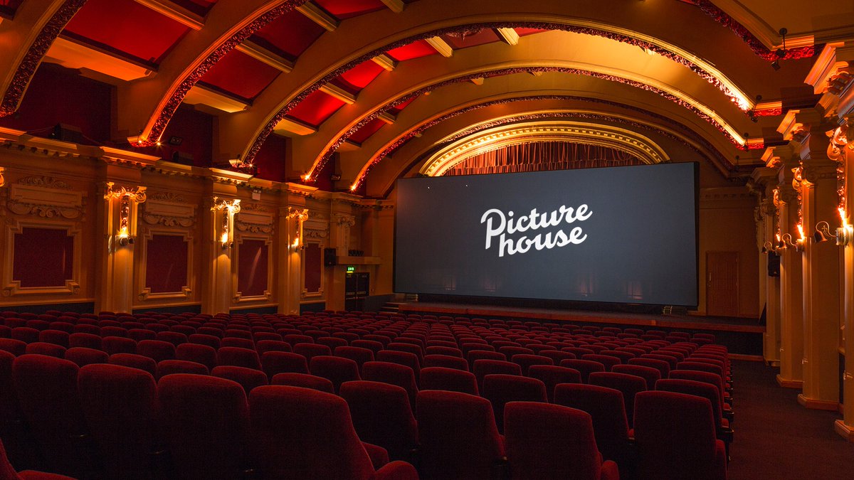 room with red chairs and a screen which says "Picturehouse"