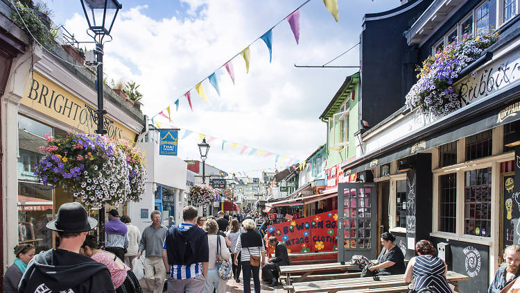 People walking in the streets of Brighton with shops on either side