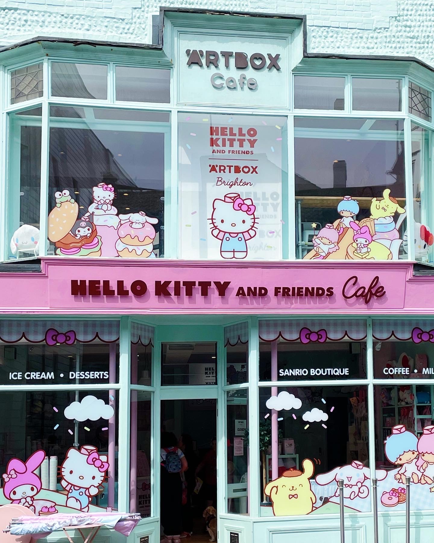outside of ARTBOX Cafe with big hello kitty character stickers in windows.