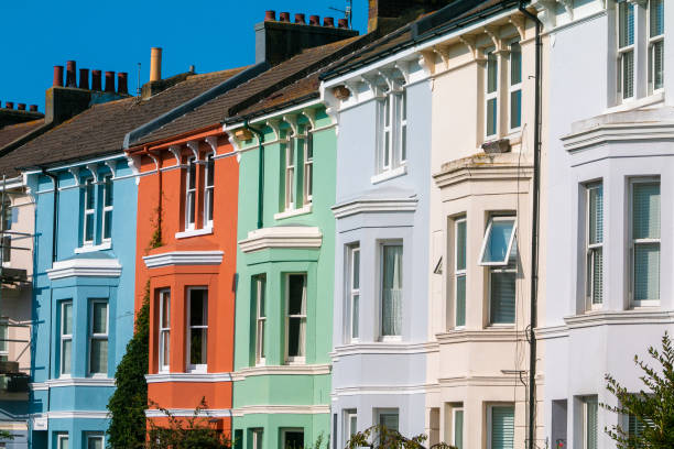 Array of coloured houses - blue,red,green,grey,beige and white.