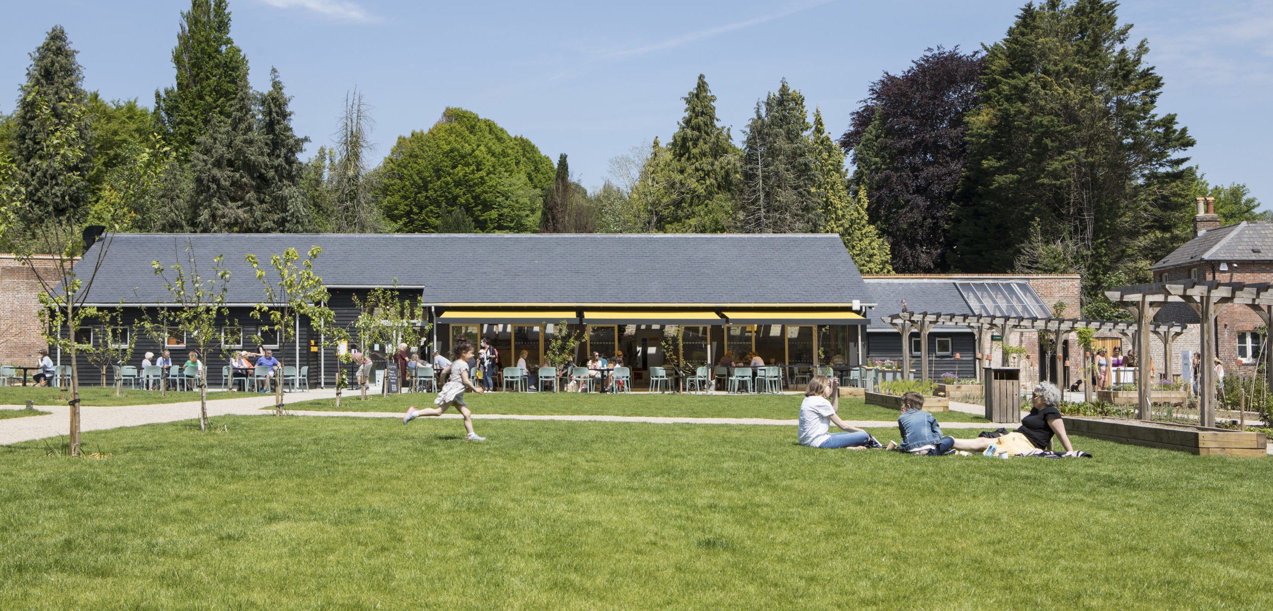 people sitting on grass in front of a building