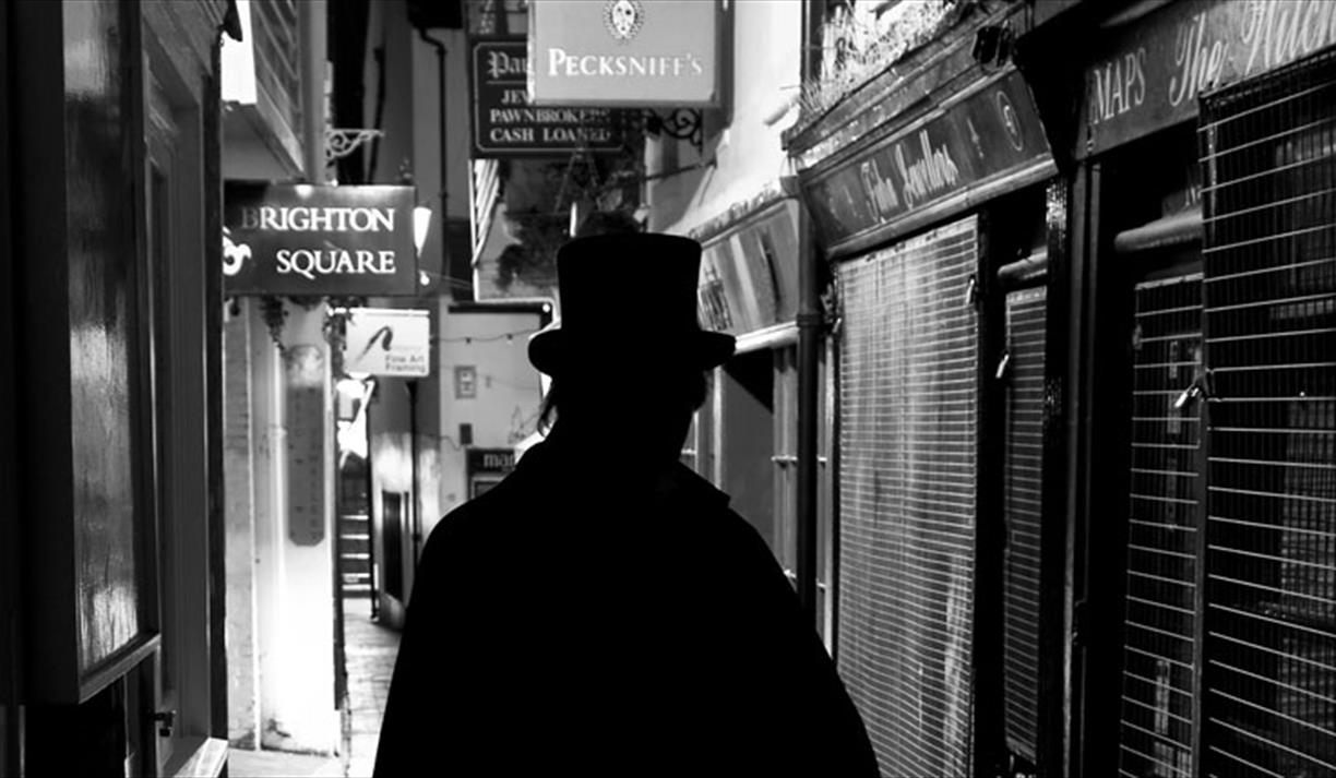 man standing in dark alley