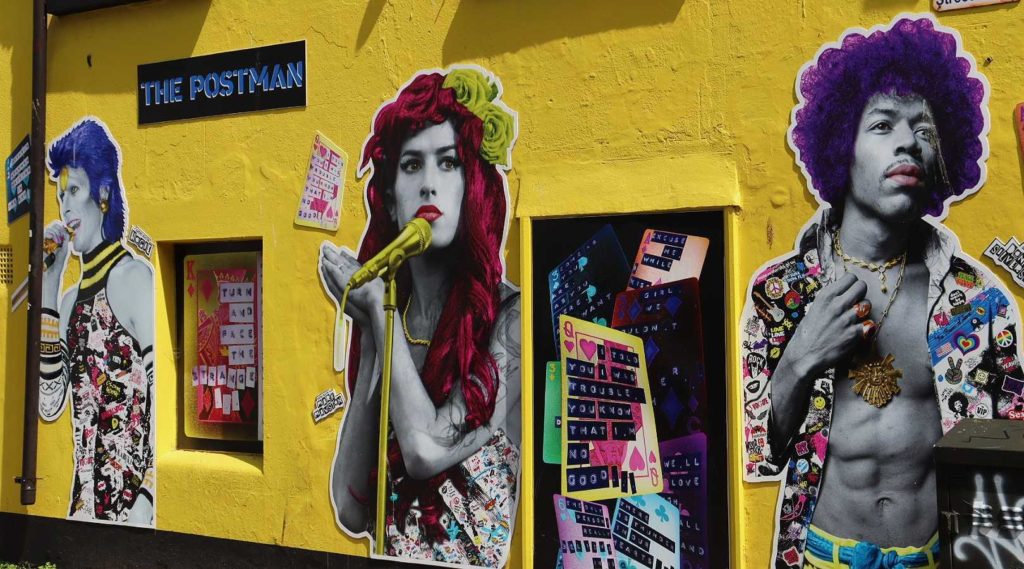 yellow wall with musical artists drawn on it