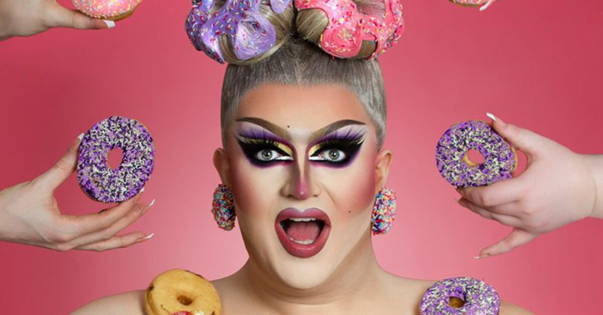 Drag queen with doughnuts being held up around