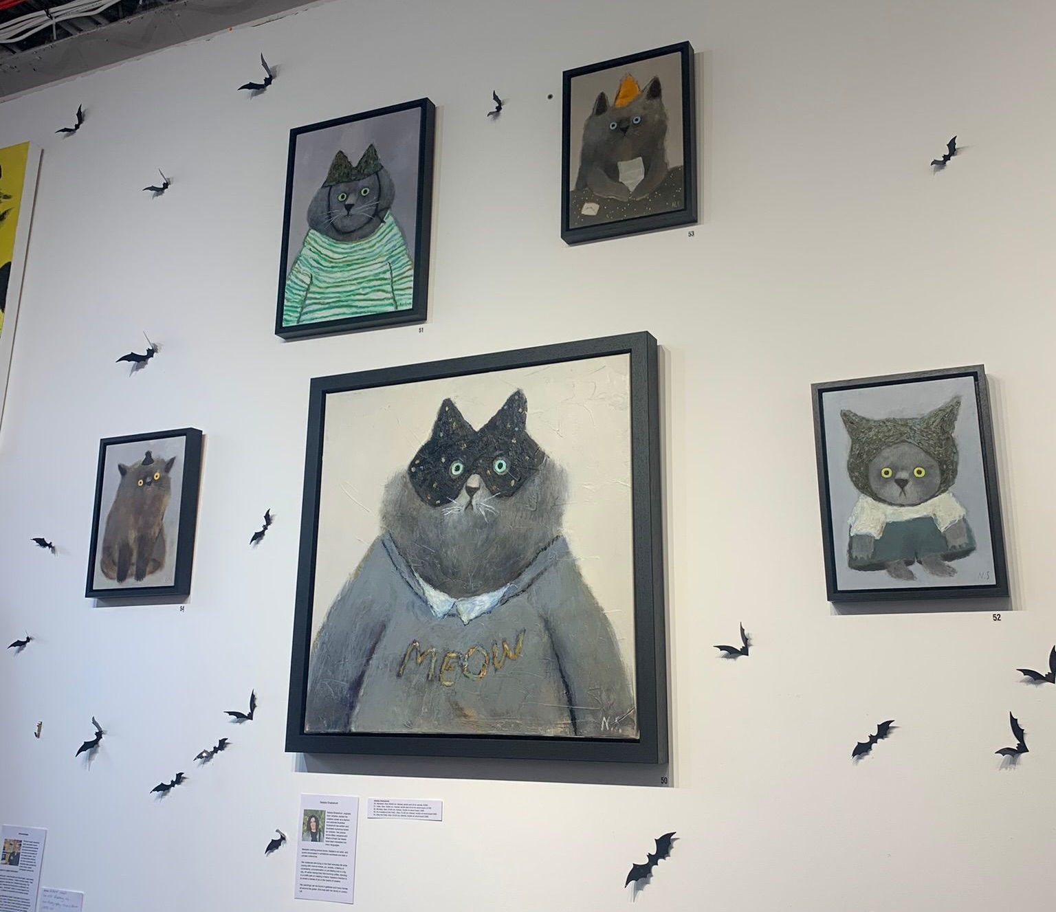 cat art hanging in frames on a white wall