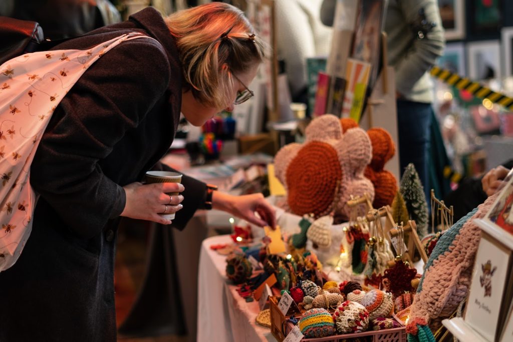 person exploring trinkets at a stall