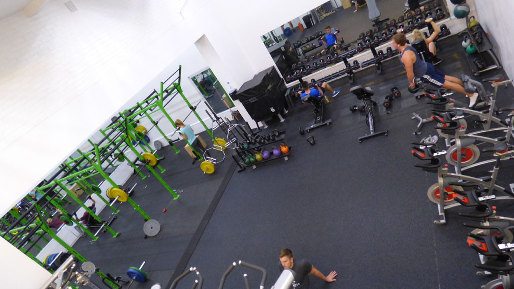 People using machinery at Sussex Sport student gym in Brighton.