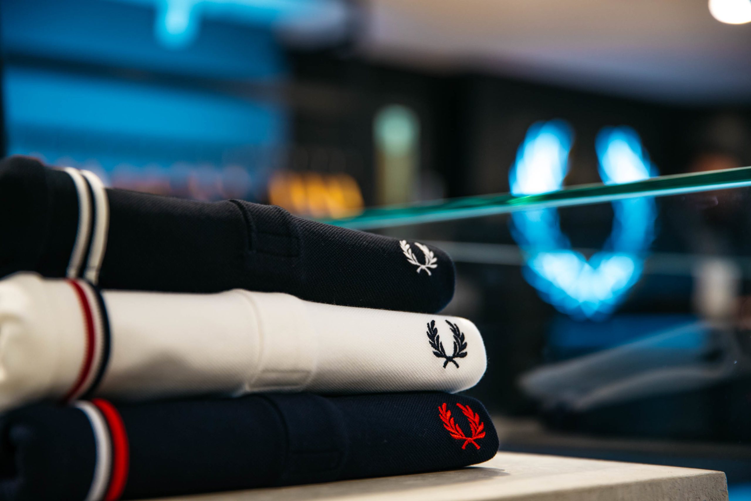 Navy, White and Black folded shirts on display at Fred Perry located in Dukes Lane in Brighton.