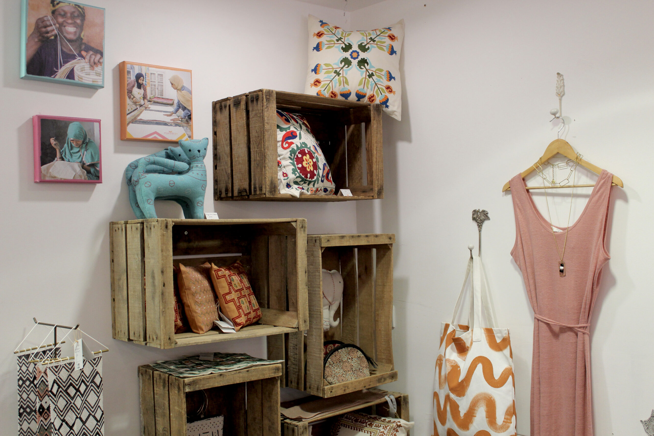 Clothes and Pillows on display in wooden crates at The Fair Shop located in Dukes Lane in Brighton.
