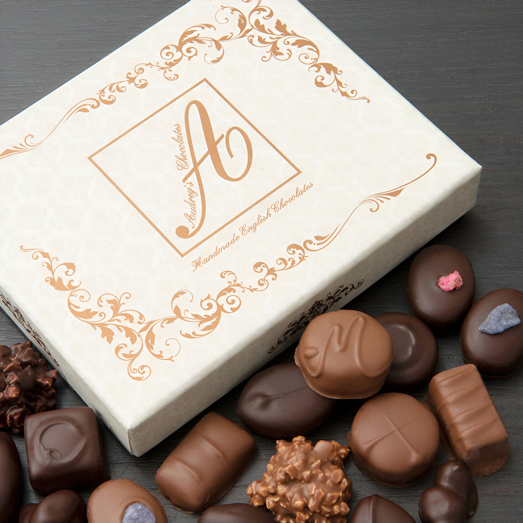 White box with fold details and chocolates arranged around it at Audrey's chocolate shop in Brighton