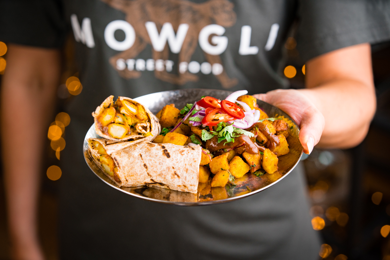 Silver plat with potatoes and chilis and wraps served at Mowgli